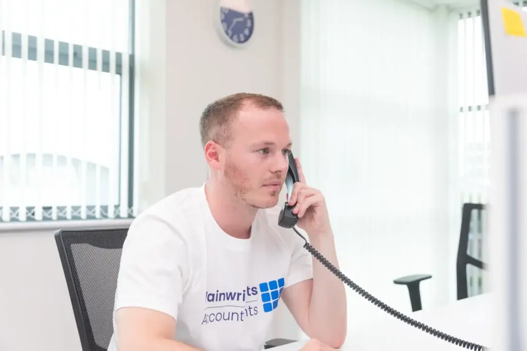 A Wainwrights accountant on the phone at the Bromborough office