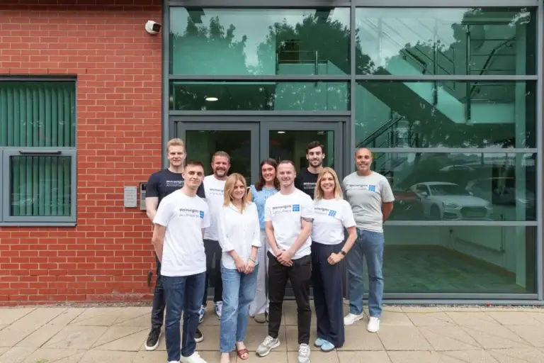 The Wainwrights Accountants team at the entrance to their Bromborough office