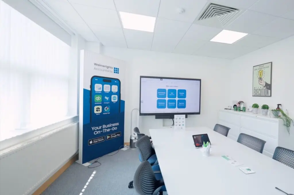 The meeting room at the Wainwrights Accountants office in Bromborough, with a long table and a large screen