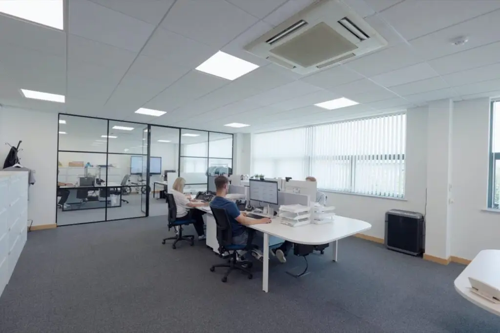 Two members of the Wainwrights Accountants team working at their desks in the Bromborough office