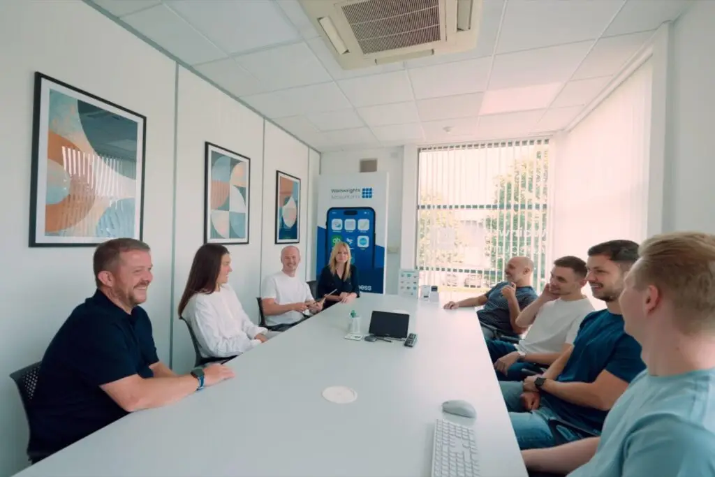 The Wainwrights Accountants team sitting around the meeting room table at the Bromborough office
