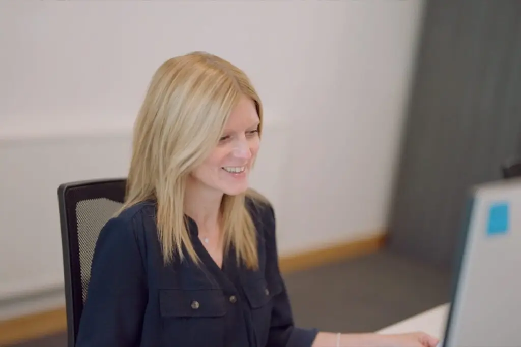 A member of the Wainwrights Accountants team working at her computer in the Bromborough office
