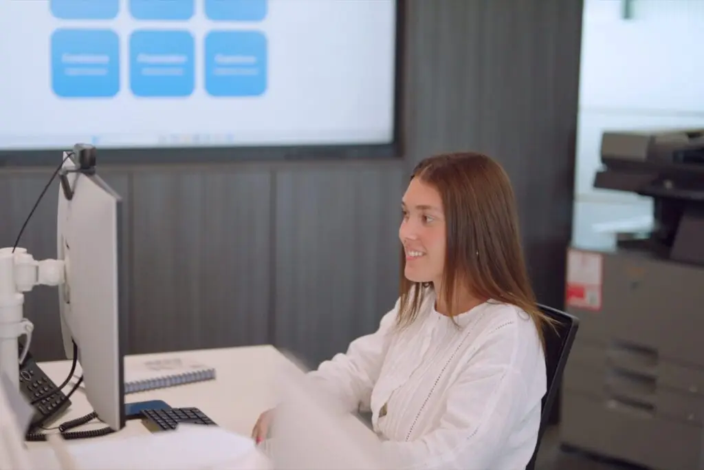 A member of the Wainwrights Accountants team at her desk, looking at her monitor