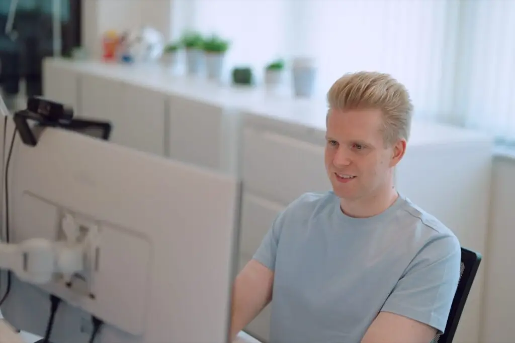A Wainwrights accountant talking on a video call at his desk, with a webcam on his monitor