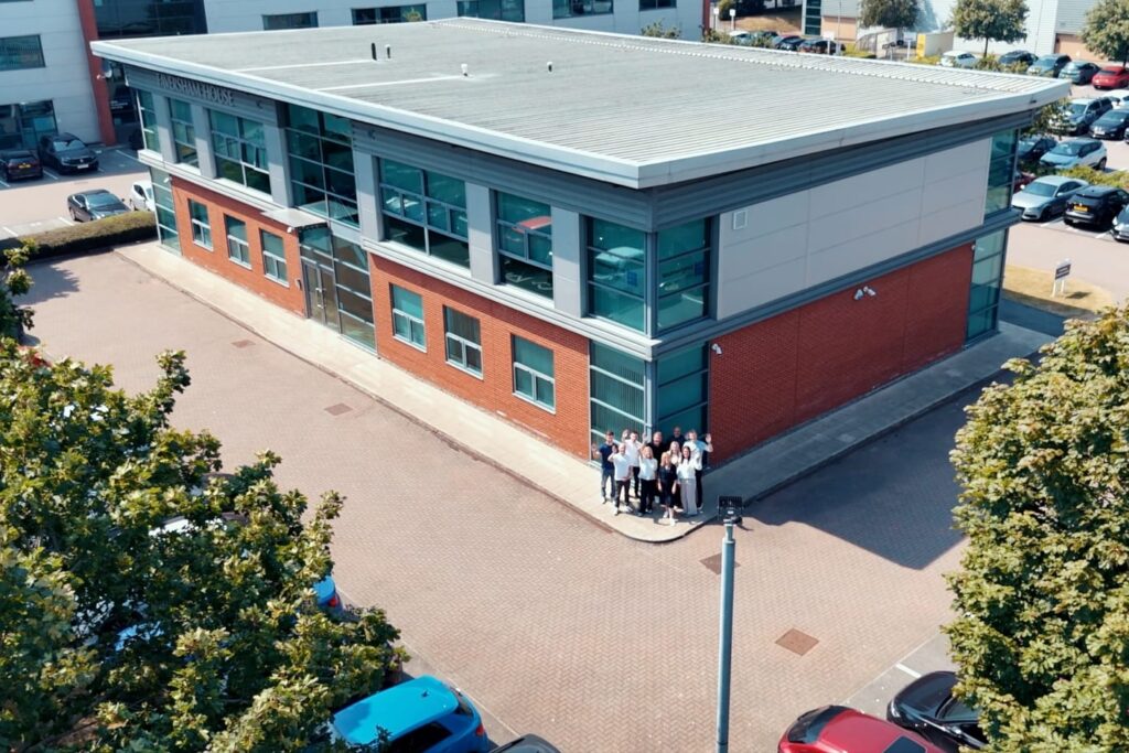 The Wainwrights Accountants team standing outside Faversham House in Bromborough, seen from above